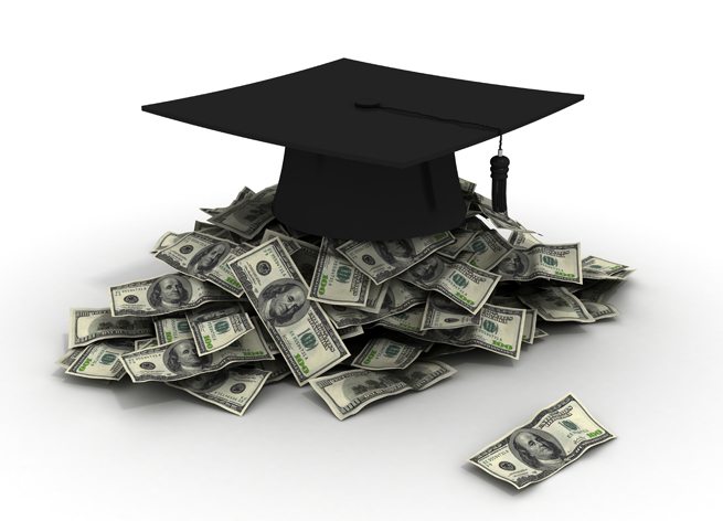 graduation cap on a pile of cash